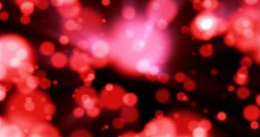 Beautiful festive bokeh effect, red love circles of light shining falling falling glowing christmas new year on black background. Abstract background. Screensaver photo