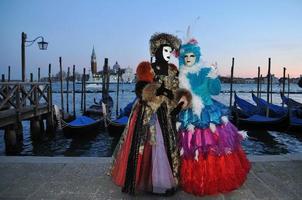 Unidentified people wearing carnival masks at the Venice Carnival in Venice, Italy, circa February 2022 photo