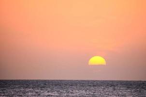 Sunset over the ocean photo