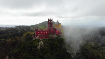 Aerial drone view of Park and National Palace of Pena in Sintra, Portugal during a foggy day. Unesco. Historic visits. Sightseeing. Fairytale. Best destinations in the world. Most visited places. video