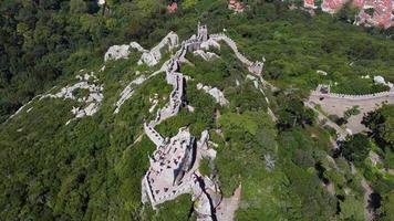 Aerial drone view of  Moorish Castle  Sintra, Portugal during a sunny day. Unesco World Heritage. Historic visits. Holidays and summer vacation tourism. Sightseeing video
