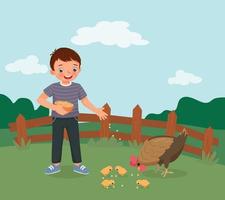 niño feliz alimentando pollos en la granja vector