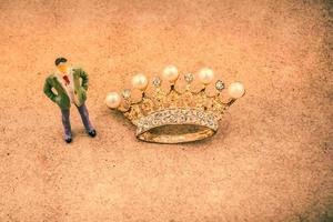 Figurine and Golden color crown model with fake pearls photo
