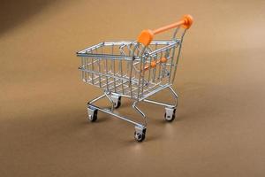 Little model shopping trolley on brown