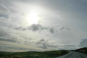 Magnificent sky over winding Icelandic road photo