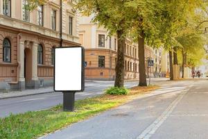 Blank billboard mock up on city road for text message or content. photo