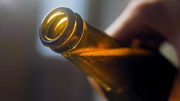 Glass with fresh and sparkling beer. In the background is a romantic atmosphere with lights video