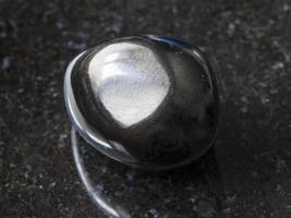 polished Gagate Jet gem stone on dark photo