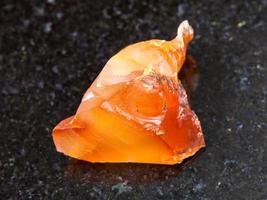 crystal of Carnelian red chalcedony on dark photo