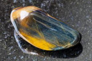 tiger's eye and hawk's eye gemstone on dark photo