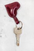 modern key with heart shape keychain on concrete photo