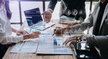 Businessman hand Project manager working and update tasks and Gantt chart scheduling virtual diagram.with smart phone, tablet and laptop photo
