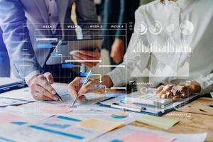 Businessman hand Project manager working and update tasks and Gantt chart scheduling virtual diagram.with smart phone, tablet and laptop in office. photo
