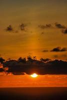 Sunset over the ocean photo