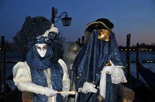 Unidentified people wearing carnival masks at the Venice Carnival in Venice, Italy, circa February 2022 photo
