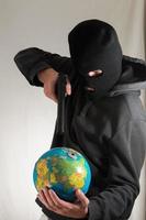 Man pointing a gun to the globe photo