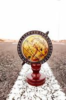 Wooden mini globe on the ground photo