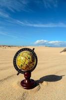 Globe on sand photo