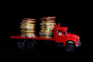 Coins on toy truck photo