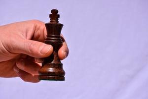 Holding a chess piece photo