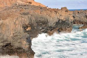 Waves hitting a rock scene photo