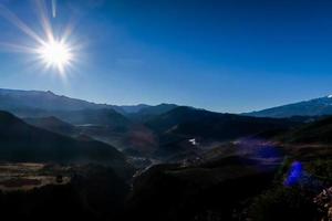 Sun over mountains photo