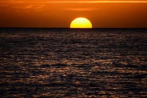 Sunset over the ocean photo