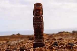 Pre-Columbian figurine on desert photo