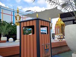 brown black wood texture cube trash can, in Taman Madiun Indonesia, sunny weather. photo