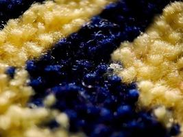 la textura de la alfombra de oración en azul oscuro y dorado. adecuado para fondo de pantalla. foto