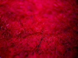 macro texture of red and gold home carpet fabric, suitable for wallpaper background. photo