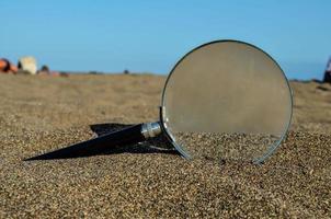 Magnifying glass in sand photo