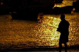 Silhouette of a person at sunset photo