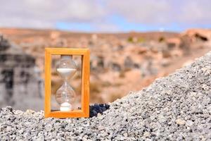 Hourglass on ground photo