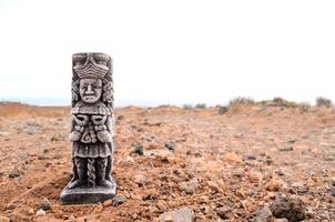 Pre-Columbian figurine on desert photo