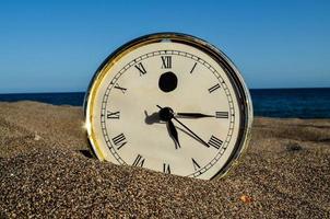 Clock in sand photo