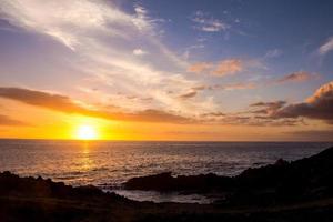 Sunset over the ocean photo