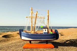 Ship miniature on the beach photo