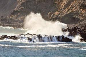 Waves hitting a rock scene photo