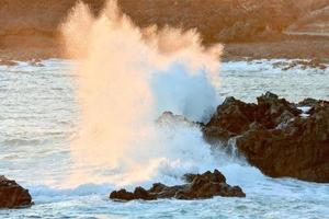 Waves hitting rocks photo