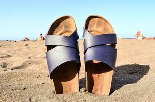 Sandals on the sand beach photo