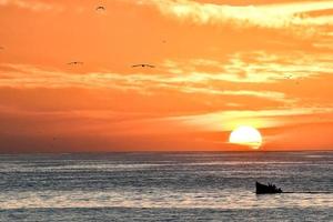 Sunset over the ocean in Morocco photo