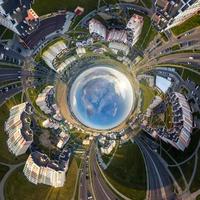 esfera azul en el interior con vistas al casco antiguo, al desarrollo urbano, a los edificios históricos y al cruce con los coches. transformación del panorama esférico 360 en vista aérea abstracta. foto