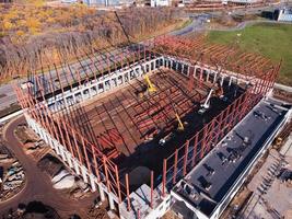 Aerial shot of unfinished metal frame of the building on a concrete base. photo