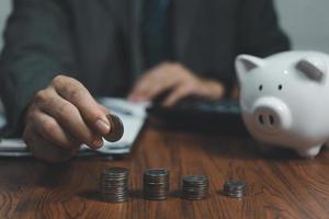 hand stacking coins on table ,Business Finance and Money concept,Save money for prepare in the future. photo