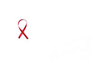 Red Support Ribbon isolated on white background. World aids day and national HIV AIDS and aging awareness month with red ribbon. copyspace area photo