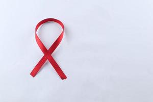 Red Support Ribbon isolated on white background. World aids day and national HIV AIDS and aging awareness month with red ribbon. copyspace area photo