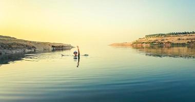 Girl in water pose dead sea in Jordan photo