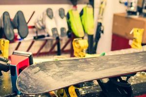 Close up waxed snowboard on repair workshop table. Step by step guide photo