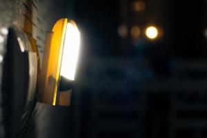 Special device connects power source and lit only when its dark at night to see switch for night walkers solution concept photo